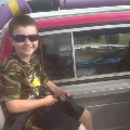 Child seated in a monster truck.